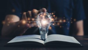 Glowing light bulb and book or text book with futuristic icon. Self learning or education knowledge and business studying concept. Idea of learning online class or e-learning at home. Glowing light bulb and book or text book with futuristic icon. Self learning or education knowledge and business studying concept. Idea of learning online class or e-learning at home.